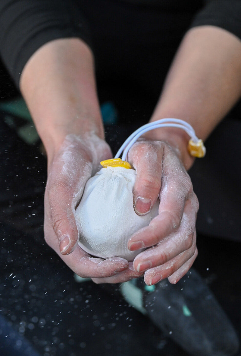 Load image into Gallery viewer, Refillable chalk ball with seawater-sourced chalk, in use
