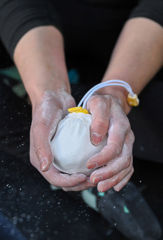 Refillable chalk ball with seawater-sourced chalk, in use